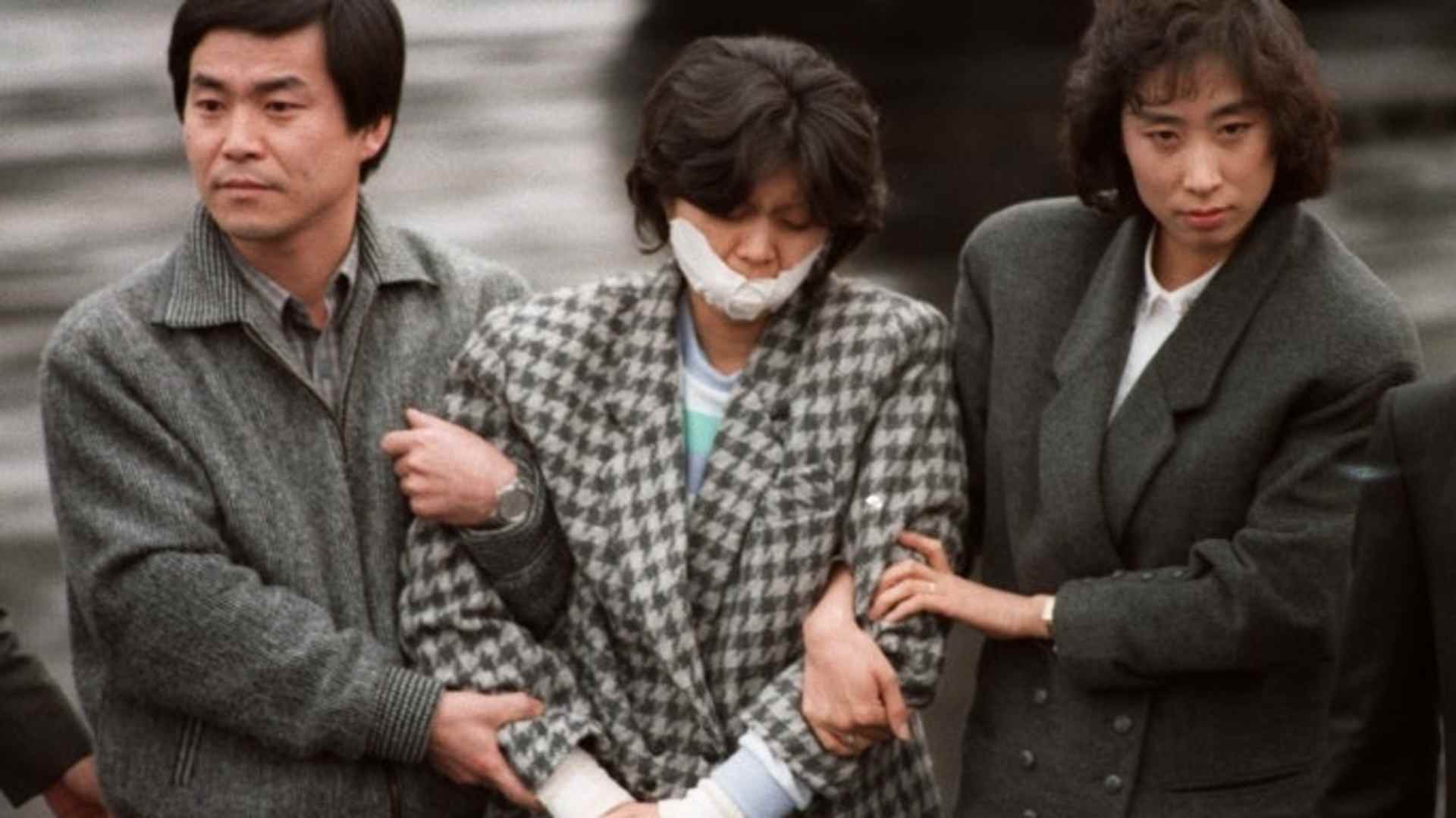 North Korean agent Kim Hyun-Hee, responsible for the Korean Air Flight 858 bombing in 1987 which killed 115 people, being escorted by South Korean investigators. (Credit: Sunkyu Im/AFP/Getty Images)
