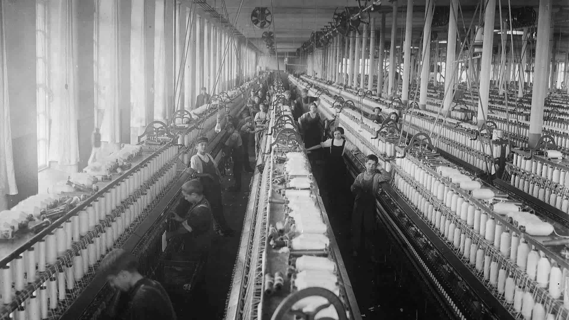 General view of a spinning room at the Cornell Mill in Fall River, Massachusetts, January 1912. (Credit: Lewis Hine/The U.S. National Archives)