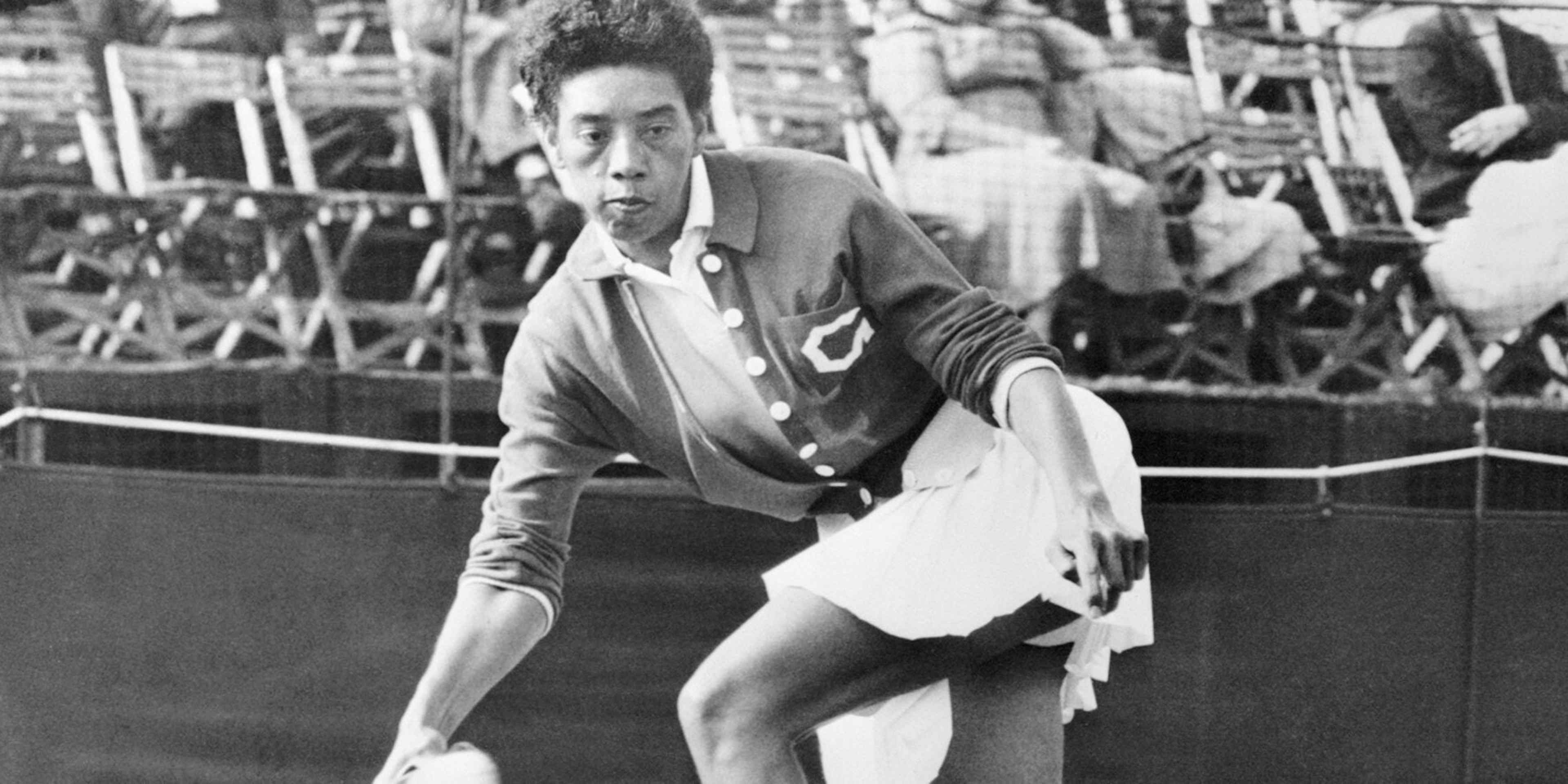 American tennis star Althea Gibson hits a return shot to Mlle. Monnot during her singles match at the Surrey Grass Court Championship, held at the Surbiton Racket and Fitness Club.