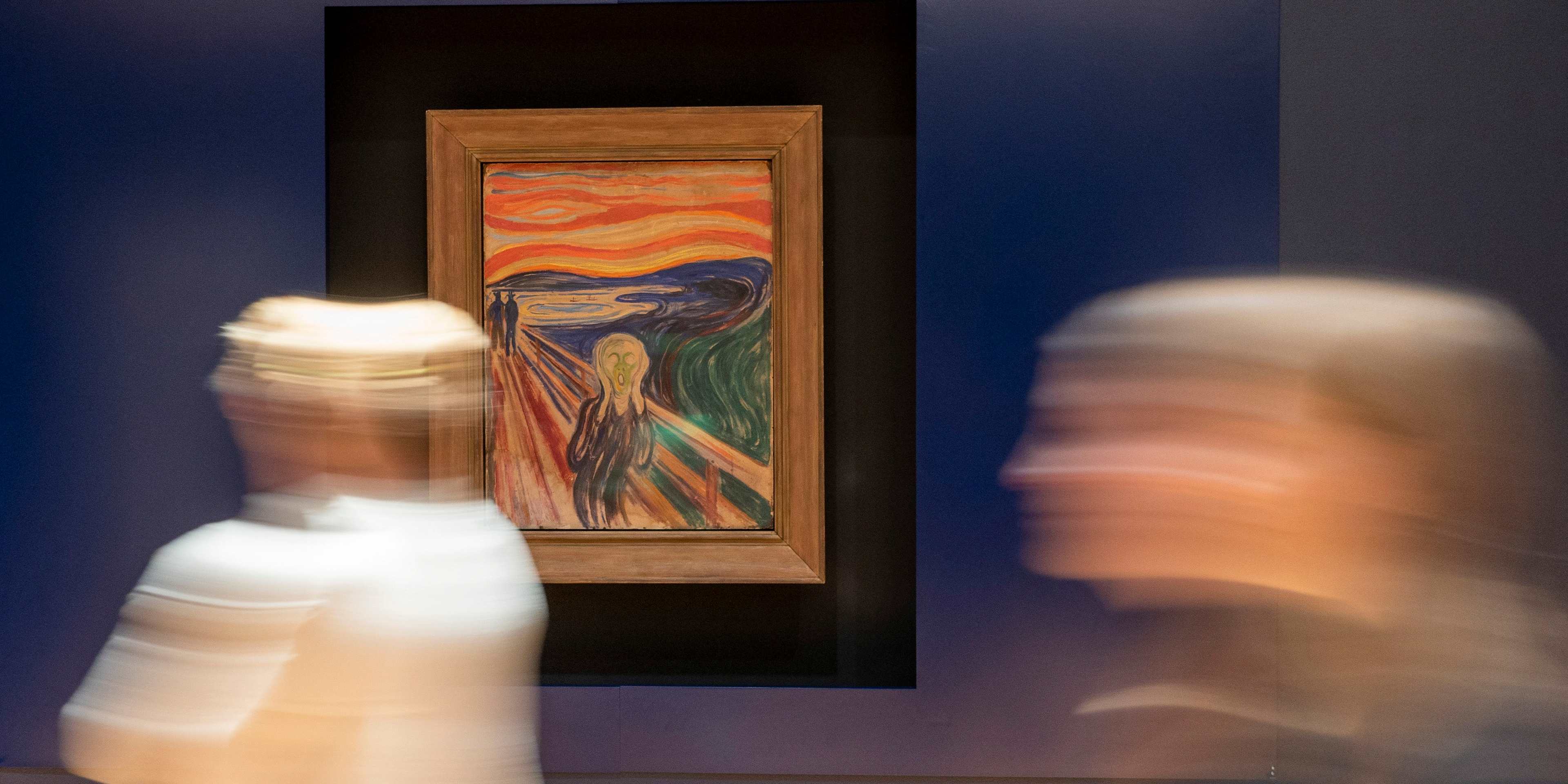 People pass by the painting "The Scream" by Norwegian artist Edvard Munch in the new Munch museum in Oslo on September 7, 2021. - On October 22, 2021, the enormous new Munch Museum opens to the public smack dab in the city centre, in a specially-designed tower that is luxuriously spacious and modern -- and which has already sparked controversy. - RESTRICTED TO EDITORIAL USE - MANDATORY MENTION OF THE ARTIST UPON PUBLICATION - TO ILLUSTRATE THE EVENT AS SPECIFIED IN THE CAPTION (Photo by Terje Pedersen / NTB / AFP) / RESTRICTED TO EDITORIAL USE - MANDATORY MENTION OF THE ARTIST UPON PUBLICATION - TO ILLUSTRATE THE EVENT AS SPECIFIED IN THE CAPTION / NORWAY IUT - RESTRICTED TO EDITORIAL USE - MANDATORY MENTION OF THE ARTIST UPON PUBLICATION - TO ILLUSTRATE THE EVENT AS SPECIFIED IN THE CAPTION (Photo by TERJE PEDERSEN/NTB/AFP via Getty Images)