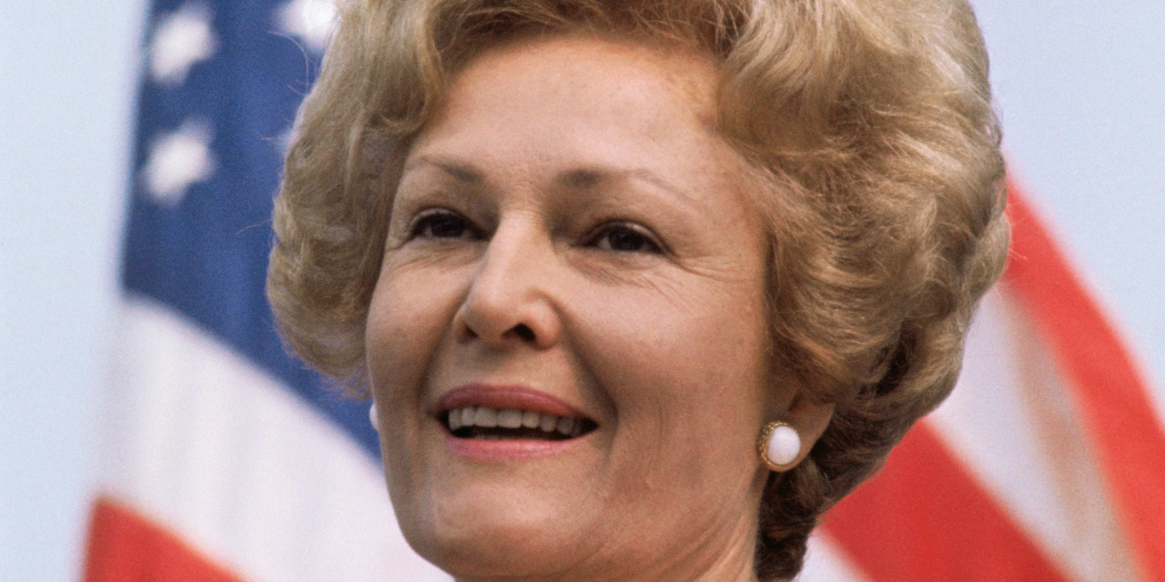 (Original Caption) McLean, Virginia: Mrs. Richard Nixon is pictured with the American flag during ceremonies at McLean, Virginia, where she started a five state visit to see the tangible results of the president's "Legacy of Parks" program.