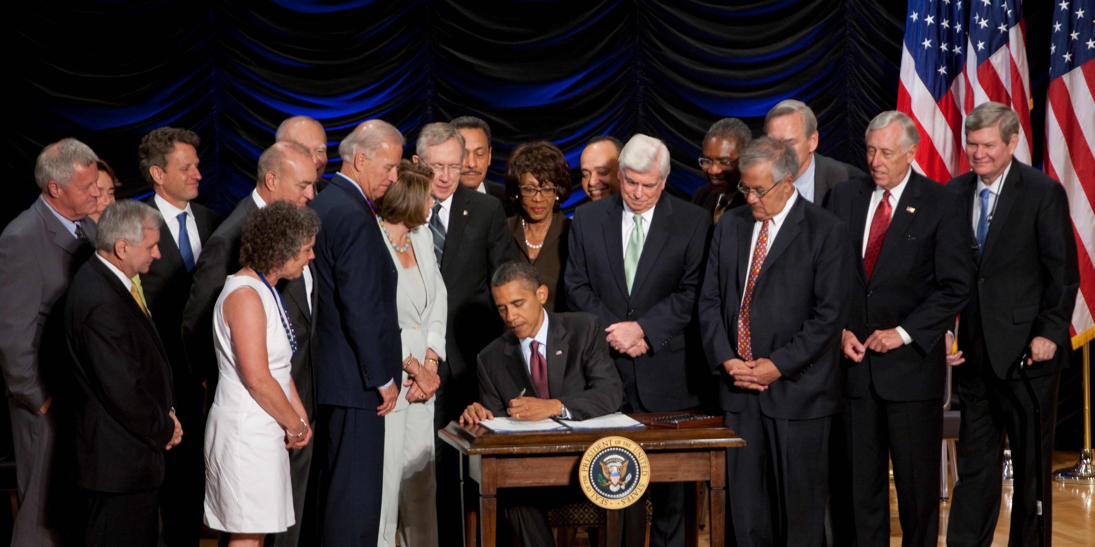 President Barack Obama signs the Dodd-Frank Wall Street Reform and Consumer Protection financial overhaul bill at the Ronald Reagan Building in Washington. Pictured from left to right: Rep. Collin Peterson, D-Minn., Sen. Jack Reed, D-R.I., Sen. Blanche Lincoln, D-Ark., Treasury Secretary Timothy Geithner, teacher Robin Fox, Vietnam veteran Andrew Giordano, Rep. Paul Kanjorski, D-Pa., Vice President Joe Biden, House Speaker Nancy Pelosi, D-Calif., Senate Majority Leader Harry Reid, D-Nev., Rep. M (Photo by Brooks Kraft LLC/Corbis via Getty Images)