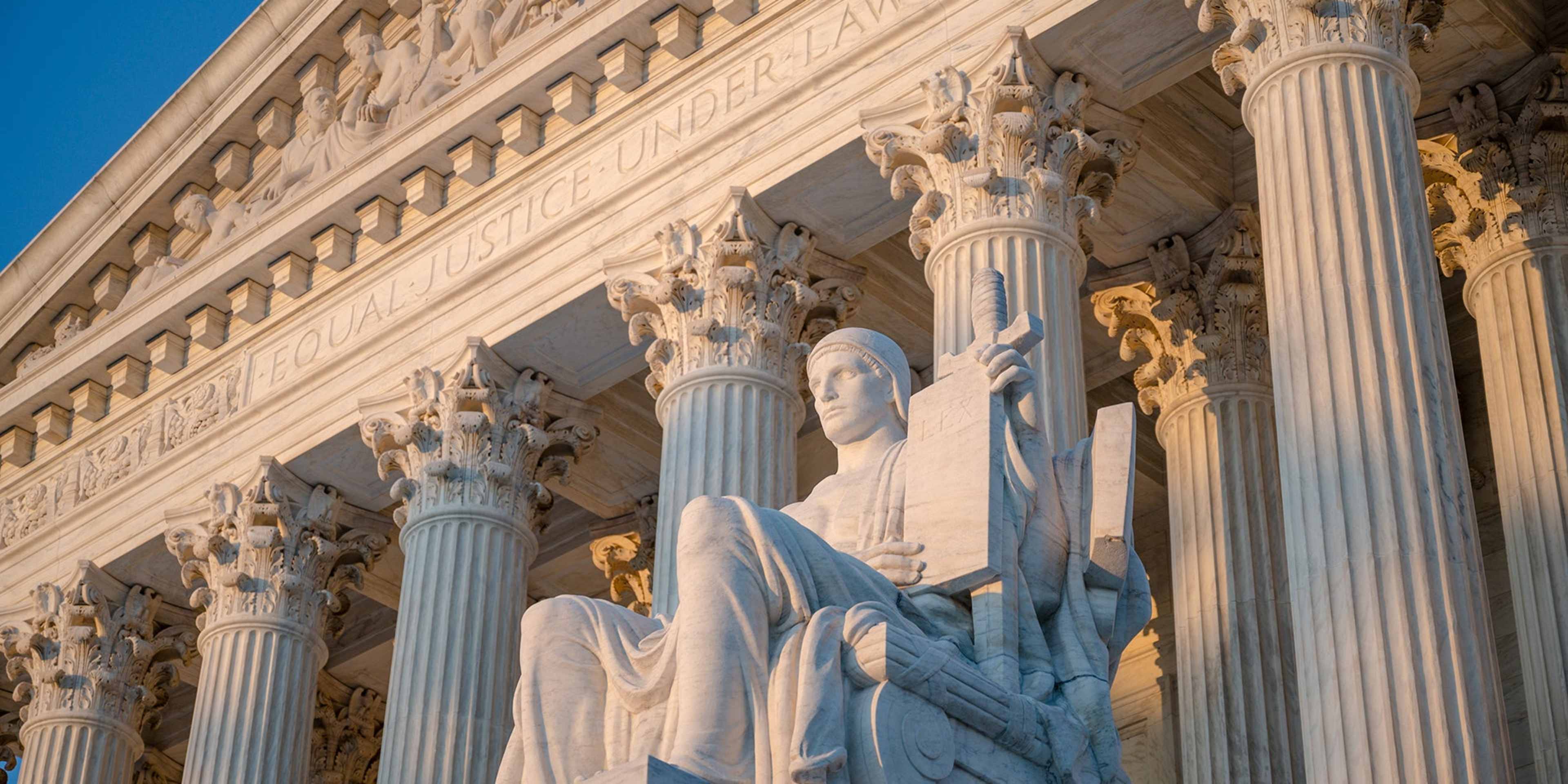 Exterior of Supreme Court of the United States on First Street in Washington, D.C., with statue by James Earle Fraser titled Authority of Law.