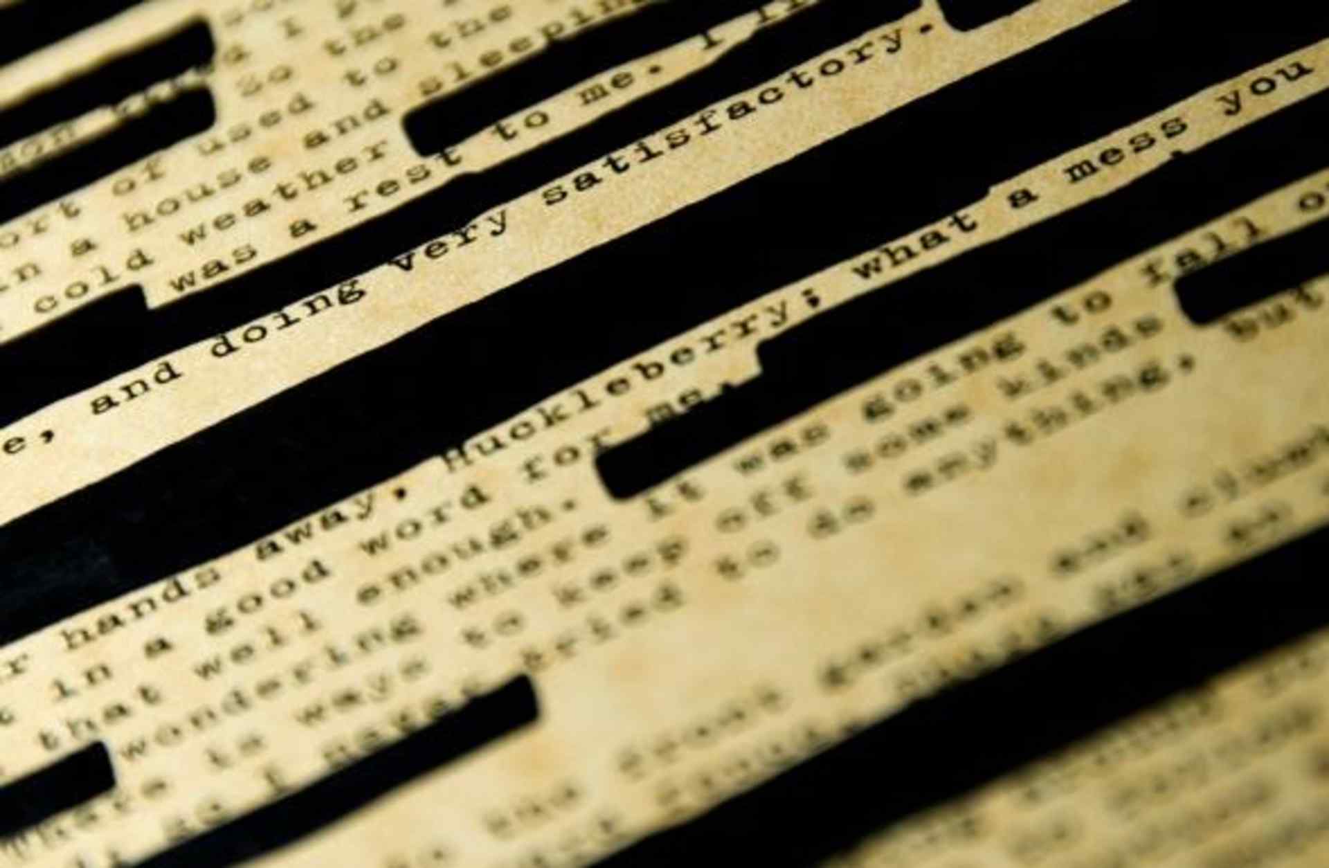 A page of Huckleberry Finn with redacted passages.