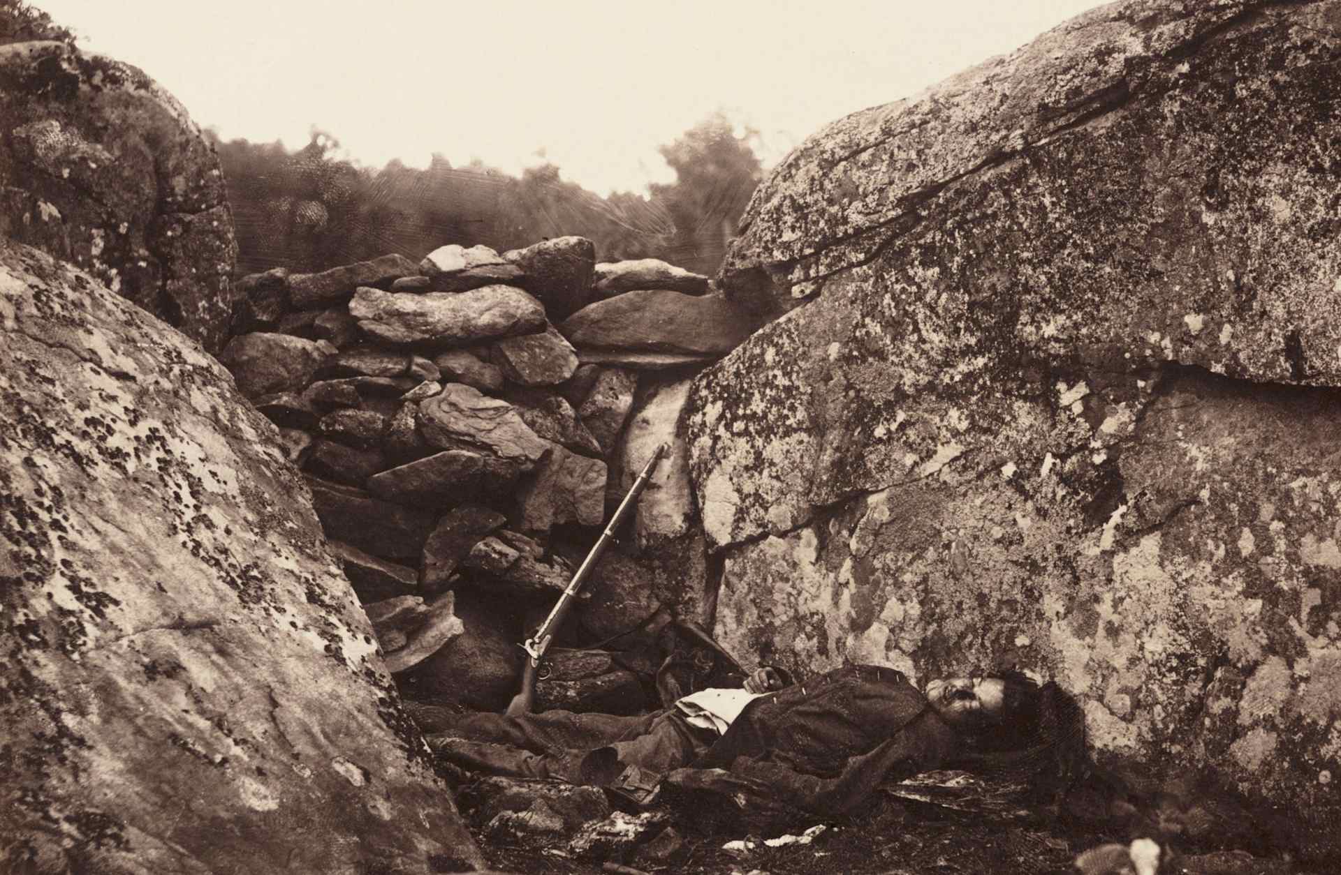 A print of a dead soldier at Devil's Den on the battlefield at Gettysburg, by Alexander Gardener (1821-1882) from a negative produced by Timothy H O'Sullivan (1840-1882). The Devil's Den was the scene of bitter fighting during the second day of the Battle of Gettysburg.