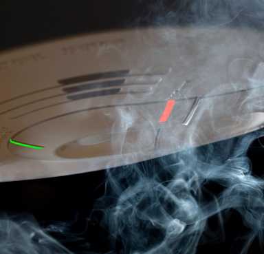 Smoke crawling over smoke detector.