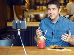 A micro-influencer at a restaurant, talking to their followers, showcasing their affiliate marketing value