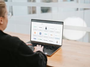 Employee on their computer looking at the 2024 Power 100, Awin's most innovative partners
