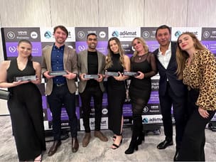 Seven people, including five Awin employees, holding the prizes at the Global Performance Marketing Awards.