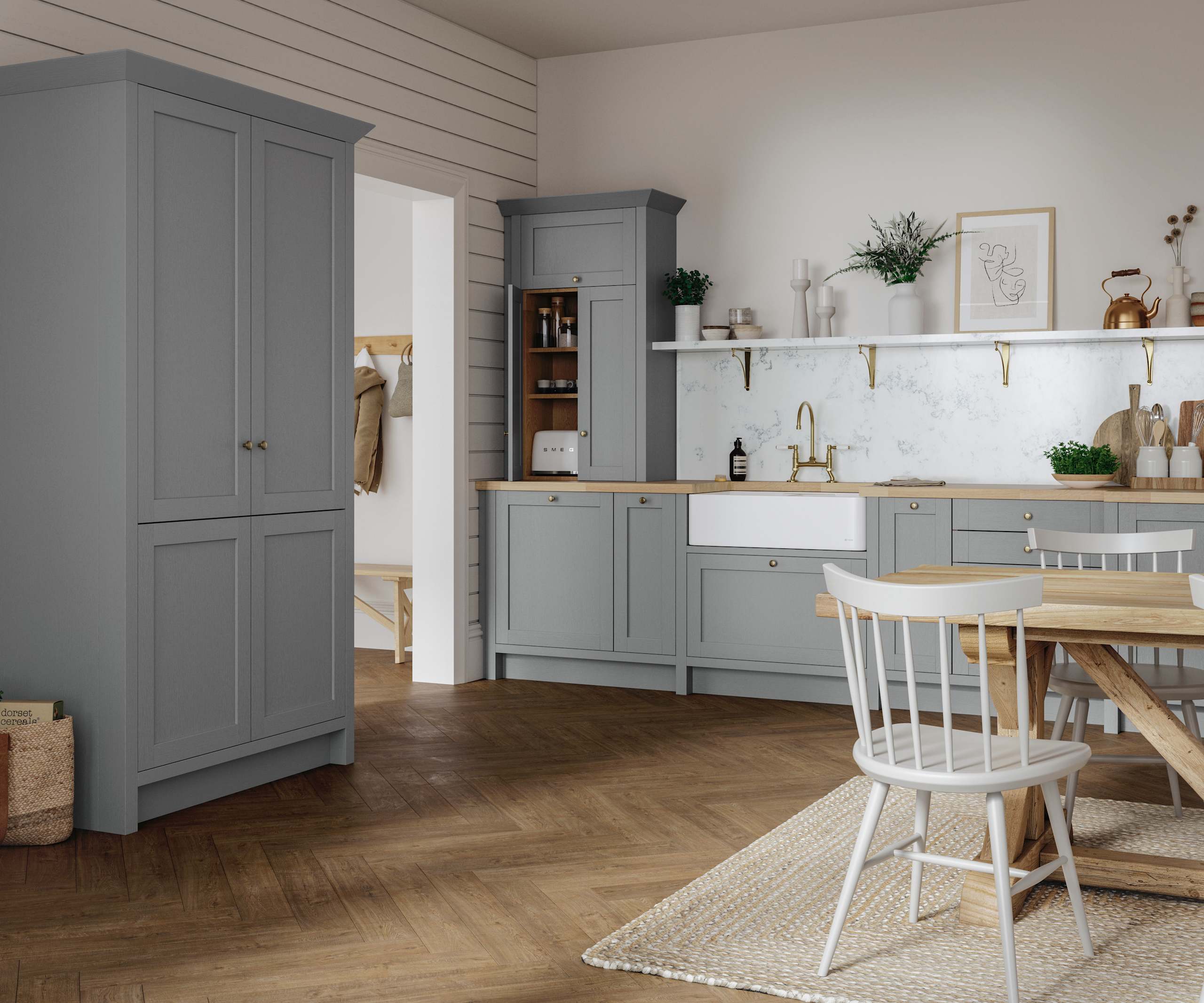 A grey Shaker Ambleside kitchen with a traditional wooden dining table and wooden flooring.