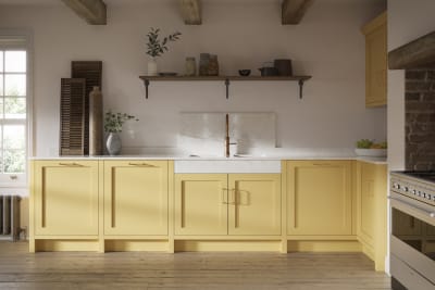 Shaker kitchen in the bright and beautiful yellow shade Harvest, paired with open wooden shelf and a marbled worktop.