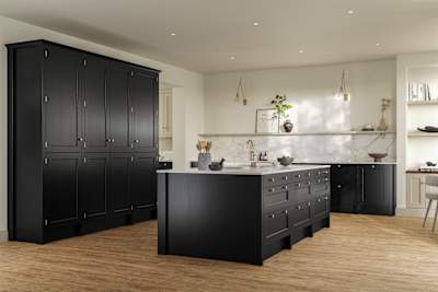 Traditional Shaker-style tactile woodgrain Ludlow Sumi Black kitchen with tall cabinets and kitchen island, brass accessories, marbled white and grey worktop, Amtico oak stripwood vinyl flooring.