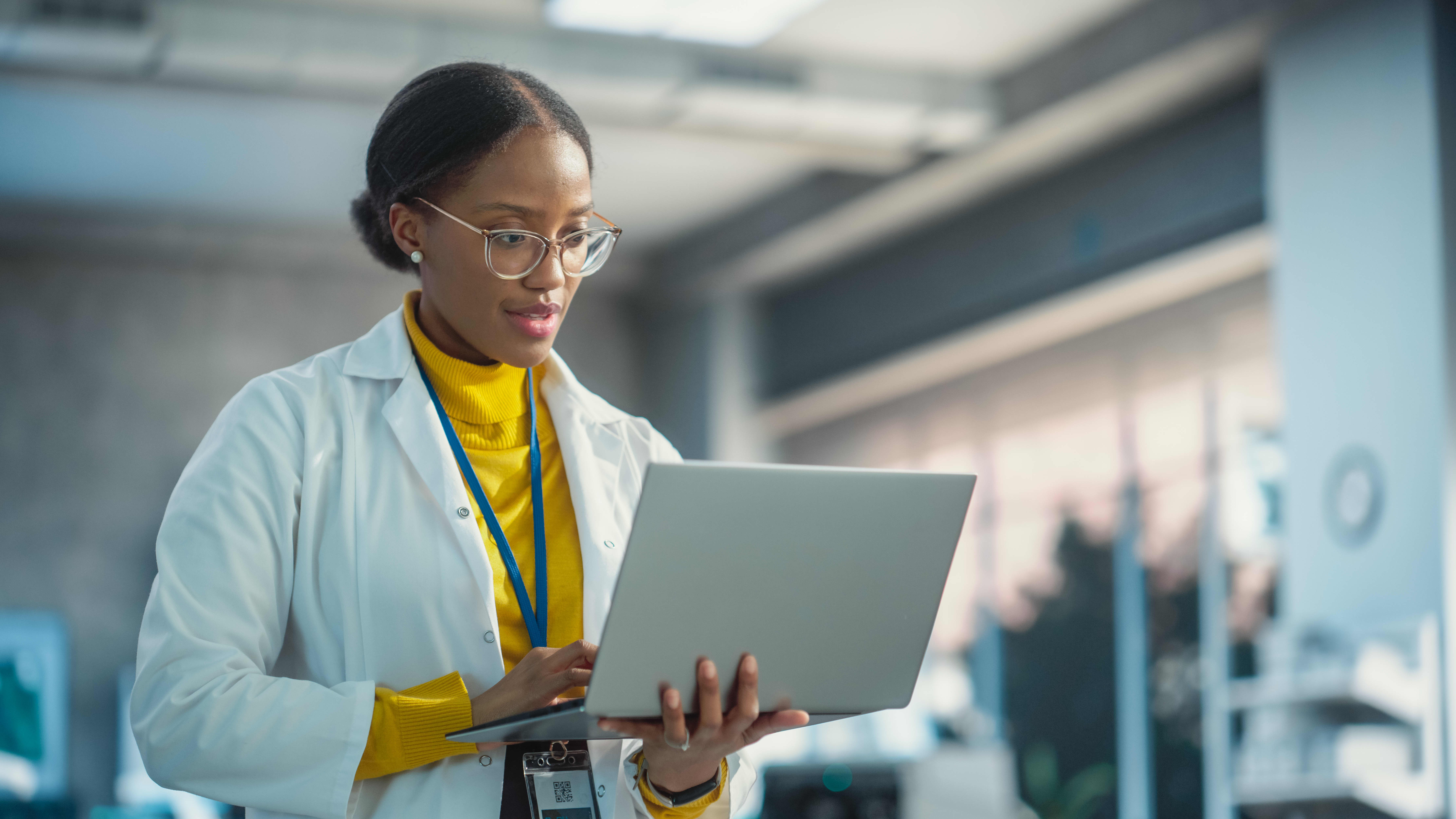 Doctoral Graduate Works in Office on Laptop