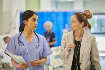 Two colleagues discuss hospital affairs.