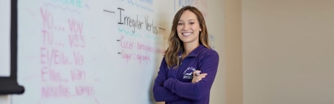 student in front of whiteboard learning spanish