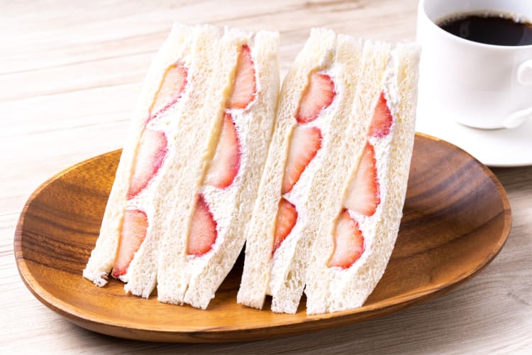 A sandwich with cream and strawberry filling