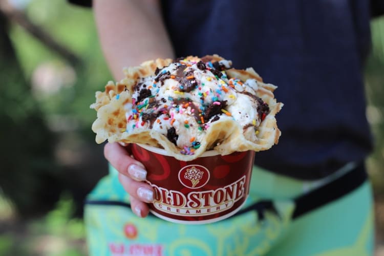 Cold stone ice cream topped with fudge and sprinkles