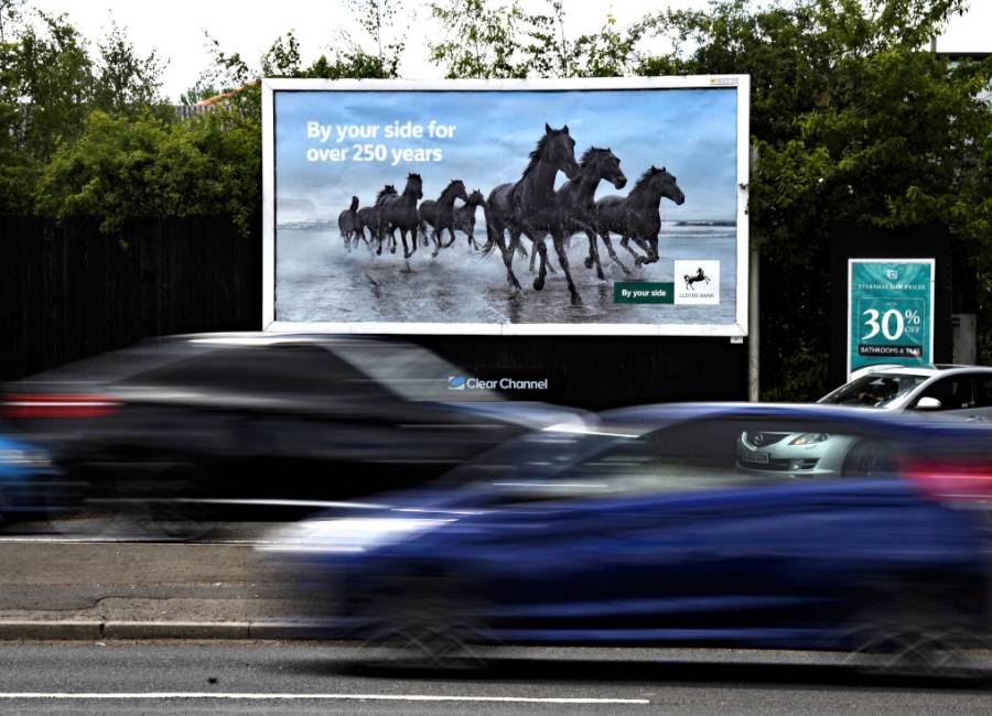 large billboard by roadside with Lloyds Bank advert