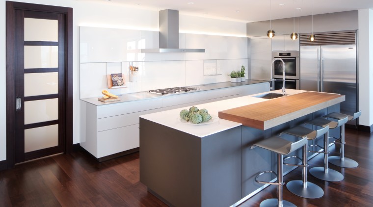 ​​​​​​​This entertainer’s kitchen by Kitchen Distributors includes a cabinetry, countertop, interior design, kitchen, white, timber floor, 