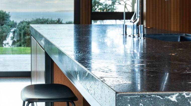 ​​​​​​​The leathered granite island benchtop adds textural interest architecture, building, cabinetry, countertop, floor, flooring, furniture, glass, granite, home, house, interior design, kitchen, marble, material property, property, room, table, tile, window, white, black